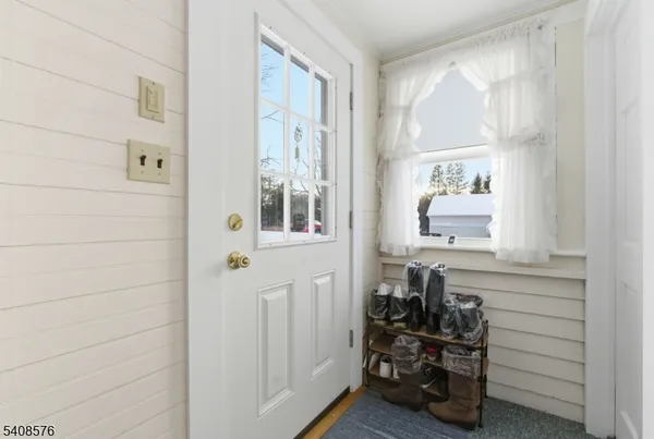 a view of an entryway with wooden floor and stairs