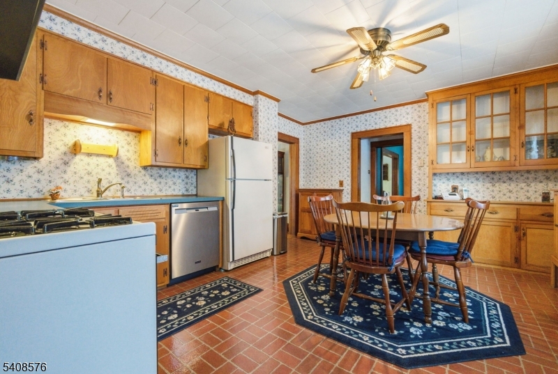 203 Johnsonburg Road Andover, NJ 07821 - Photo 15 of 42 a living room with dining table a rug a fireplace and a kitchen island