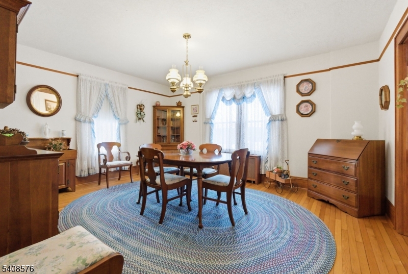 203 Johnsonburg Road Andover, NJ 07821 - Photo 19 of 42 a view of a dining room with furniture a chandelier and wooden floor