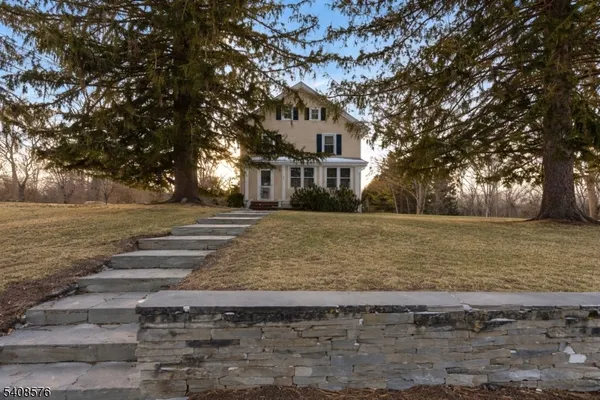 a front view of house with yard and trees