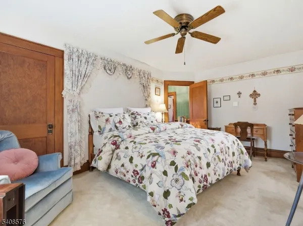 a bedroom with a bed dresser and a window