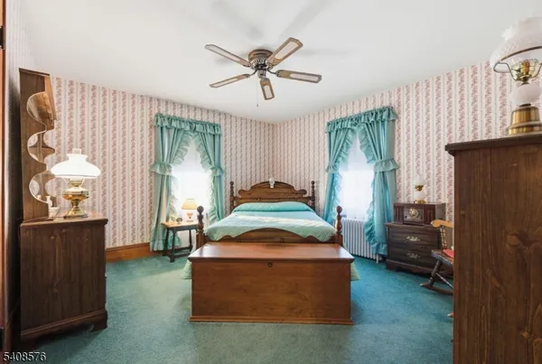 a bed room with a bed and a chair