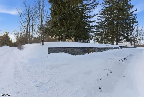 a view of a house with a snow in the yard