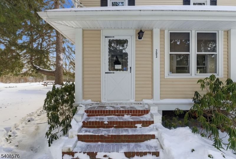 203 Johnsonburg Road Andover, NJ 07821 - Photo 7 of 42 a front view of a house with a yard