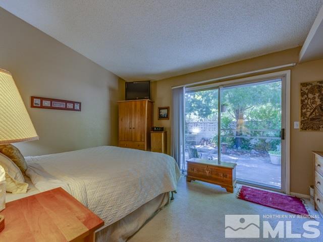 7551 Devonshire Lane Reno, NV 89511 - Photo 11 of 23 a bedroom with a bed and large window with outer view
