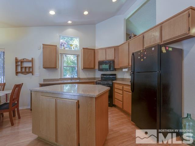 7551 Devonshire Lane Reno, NV 89511 - Photo 7 of 23 a kitchen with stainless steel appliances granite countertop a refrigerator a stove a sink and a refrigerator