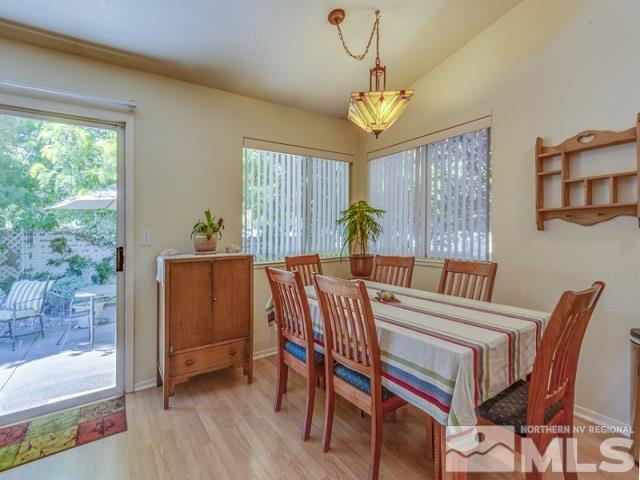 7551 Devonshire Lane Reno, NV 89511 - Photo 8 of 23 a view of a dining room with furniture a chandelier and wooden floor