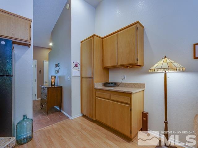 7551 Devonshire Lane Reno, NV 89511 - Photo 10 of 23 a kitchen with a refrigerator and a sink