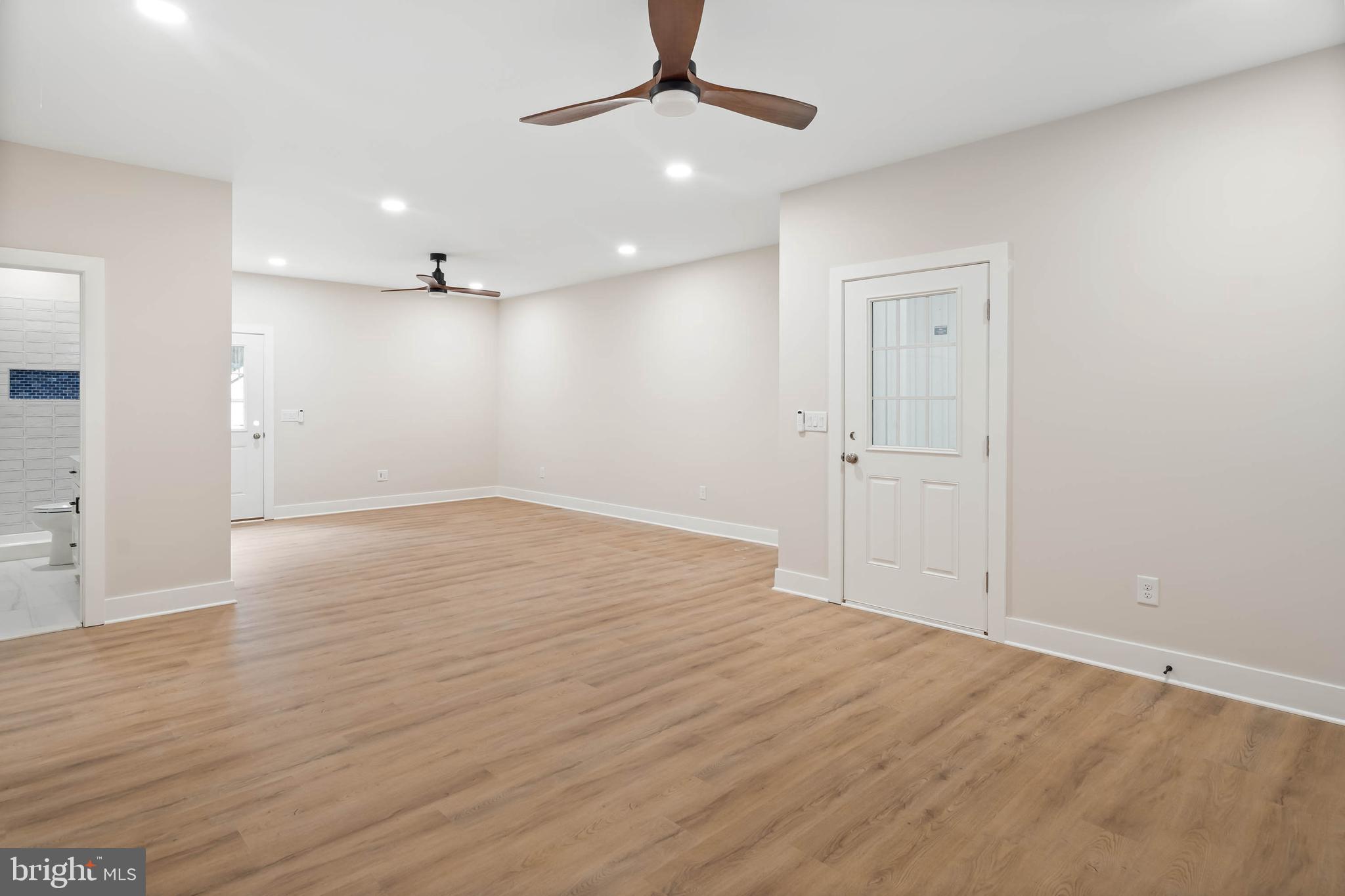 38697 Fred Hudson Road Bethany Beach, DE 19930 - Photo 13 of 51 wooden floor in an empty room with a window