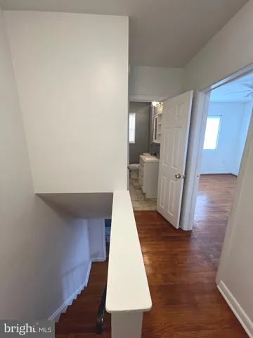 an empty room with wooden floor and white walls