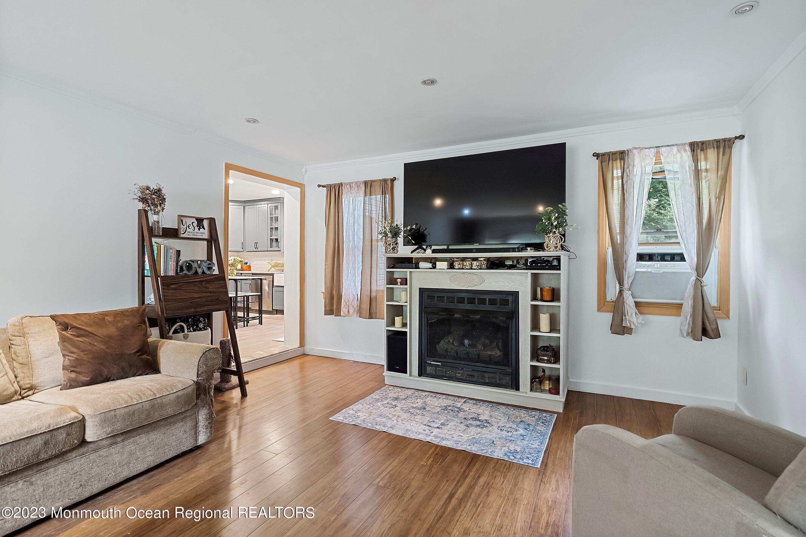 17 Murdock Place Jackson, NJ 08527 - Photo 12 of 34 a living room with furniture a flat screen tv and a fireplace