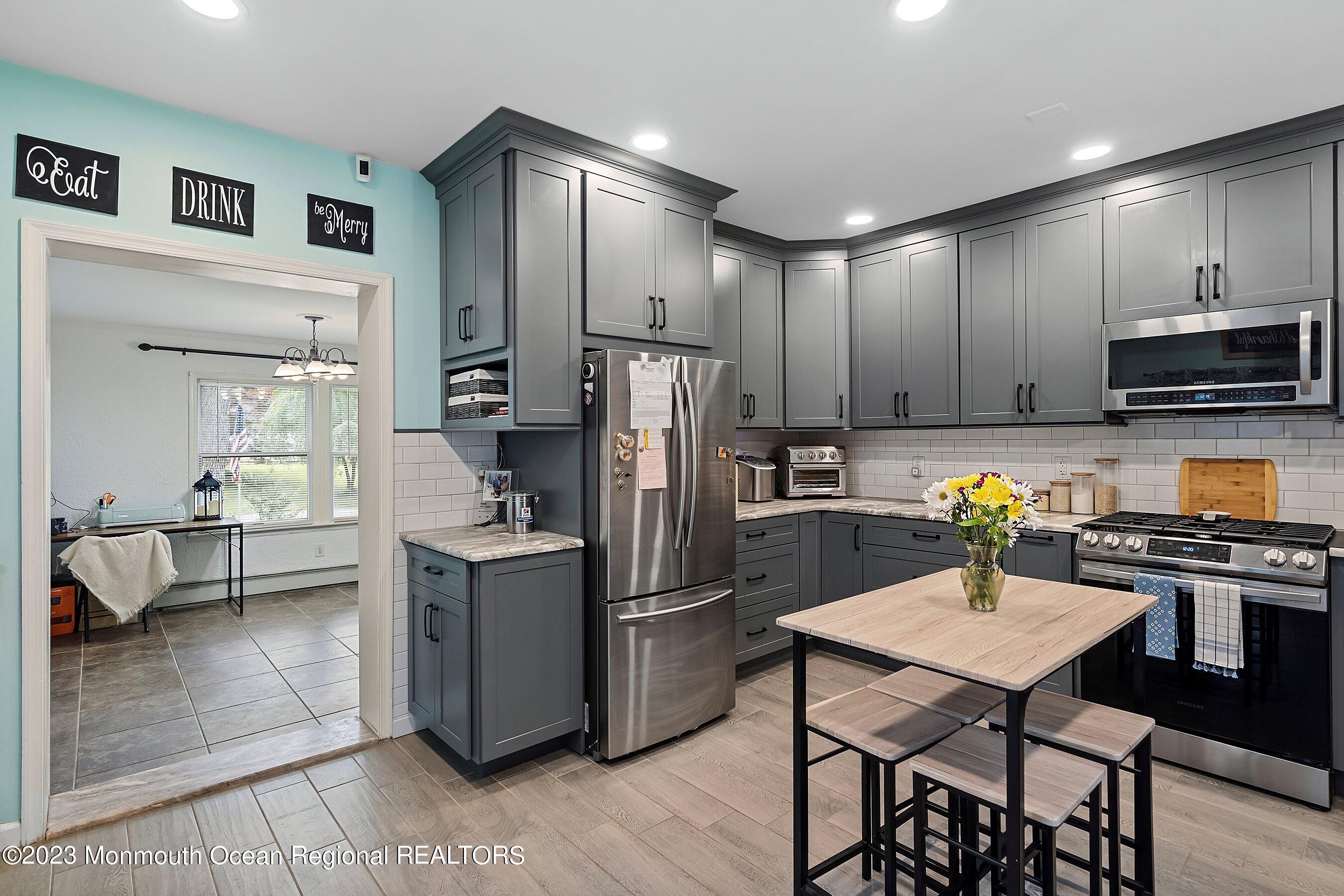 17 Murdock Place Jackson, NJ 08527 - Photo 2 of 34 a kitchen with a refrigerator a stove a sink a dining table and chairs