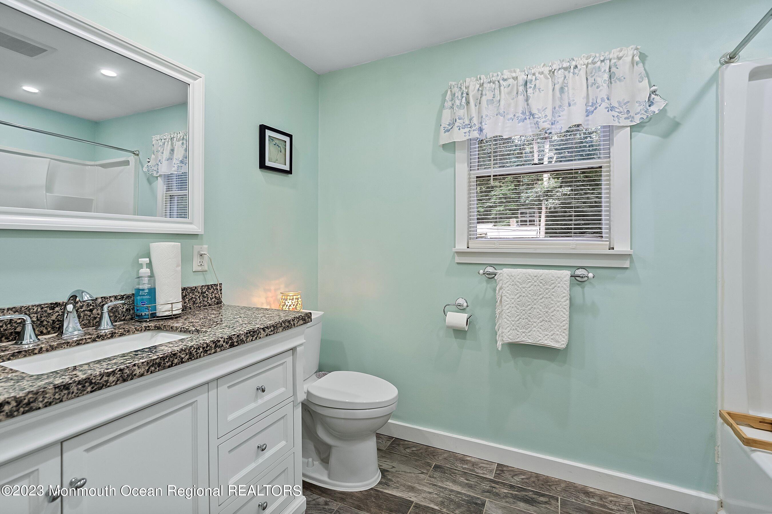 17 Murdock Place Jackson, NJ 08527 - Photo 24 of 34 a bathroom with a granite countertop sink mirror vanity and toilet