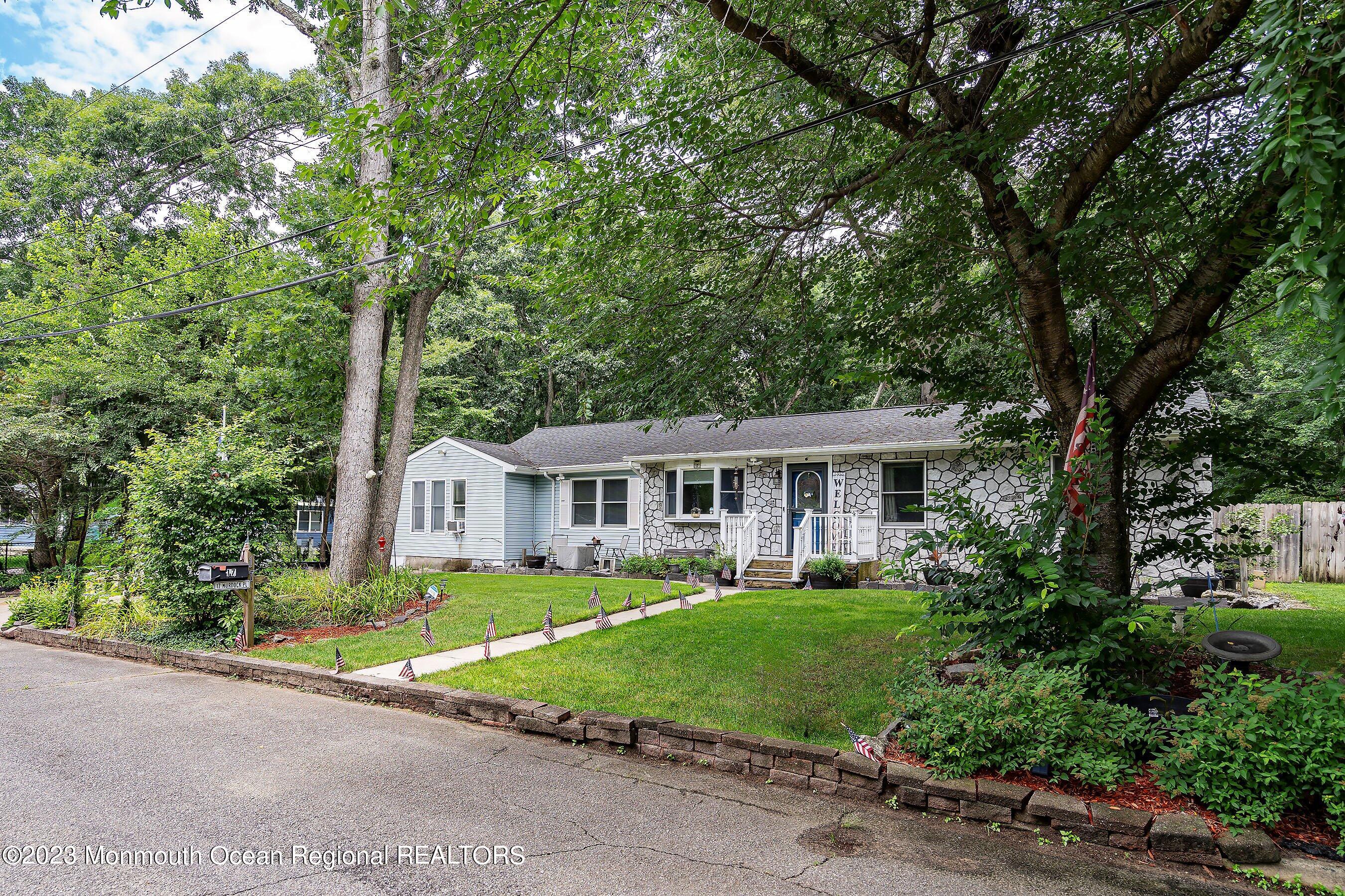 17 Murdock Place Jackson, NJ 08527 - Photo 4 of 34 a front view of a house with a garden and trees