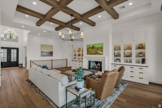 2608 Canyon Ridge Drive St. George, UT 84770 - Photo 13 of 86 Living space featuring wood-finish flooring, a coffered ceiling with recessed lighting, and a chandelier