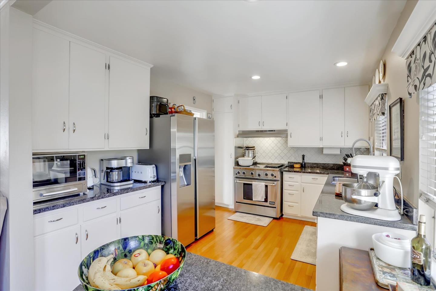 1130 Castro Street Mountain View, CA 94040 - Photo 12 of 37 a kitchen with stainless steel appliances granite countertop a refrigerator sink stove microwave and cabinets