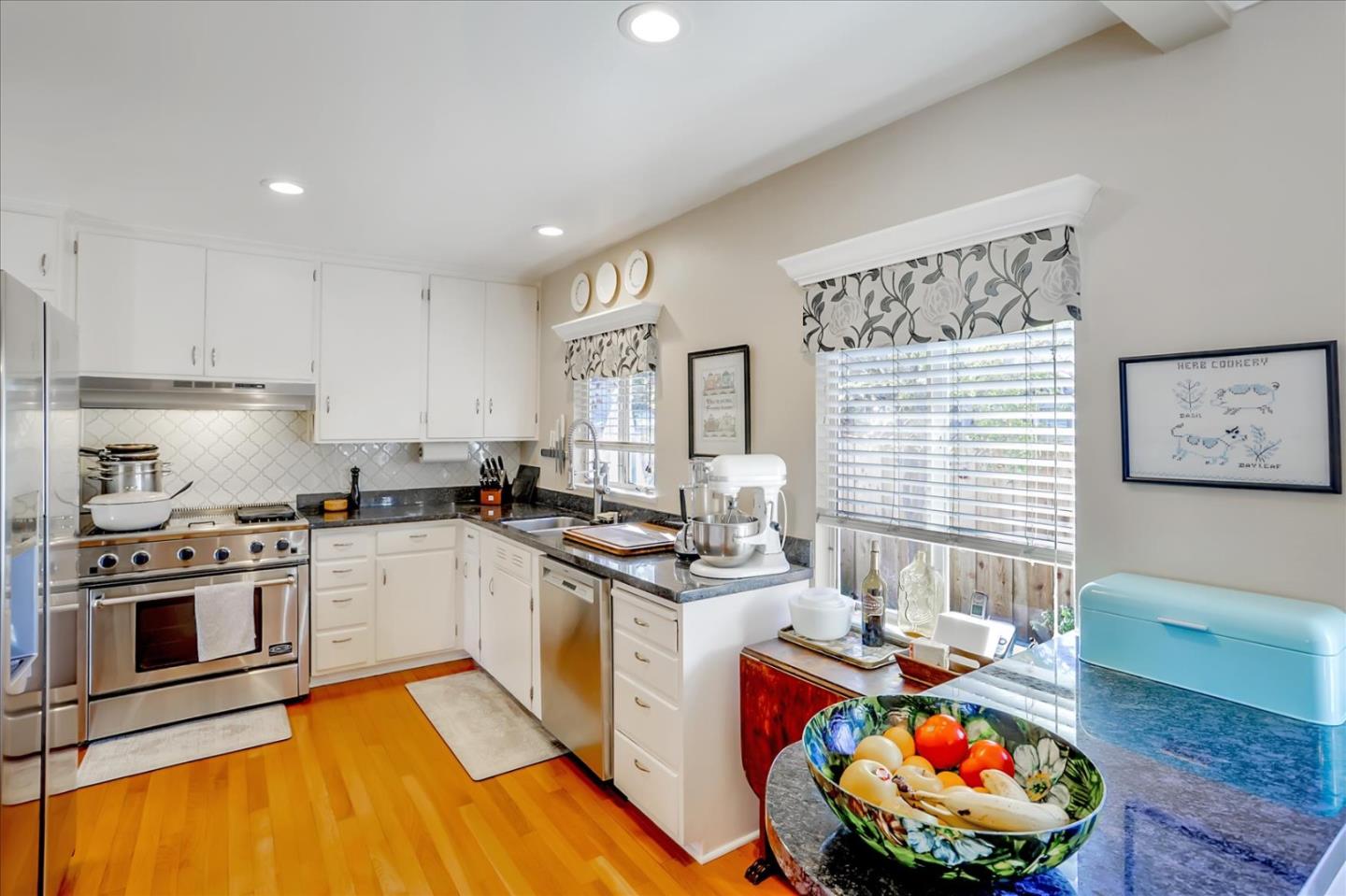 1130 Castro Street Mountain View, CA 94040 - Photo 13 of 37 a kitchen with stainless steel appliances granite countertop a stove a sink and a microwave