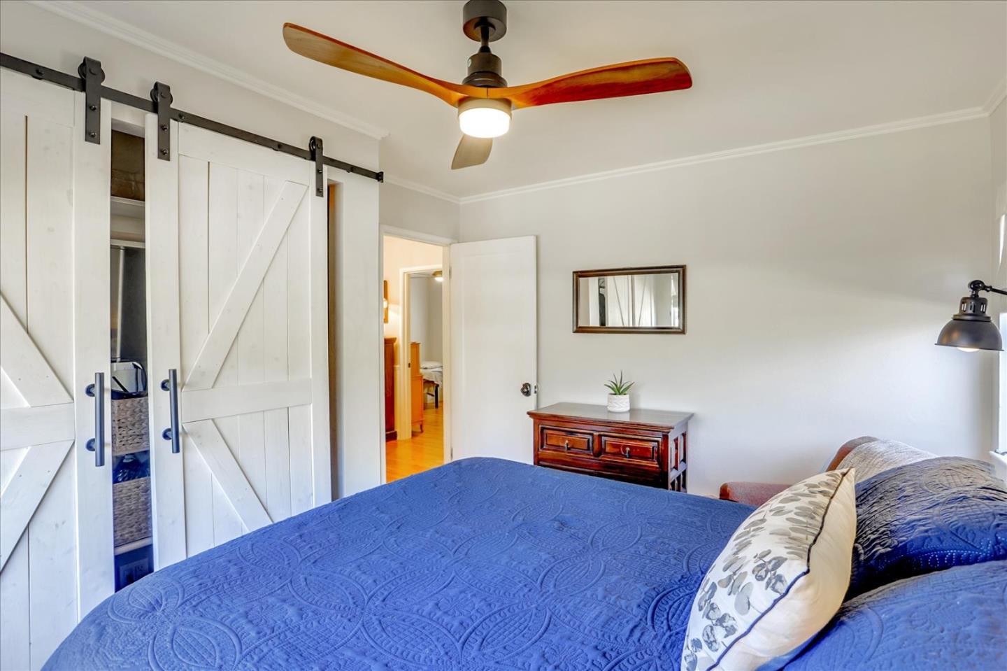 1130 Castro Street Mountain View, CA 94040 - Photo 19 of 37 a bed room with a bed and a chandelier