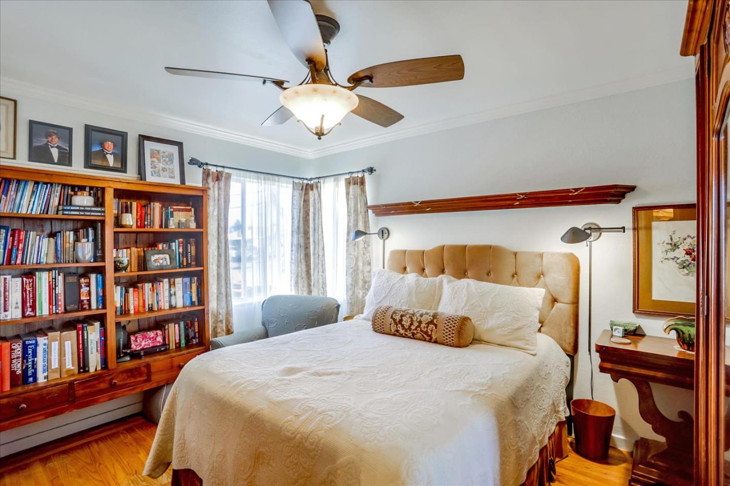 1130 Castro Street Mountain View, CA 94040 - Photo 20 of 37 a bedroom with a large bed and a book shelf
