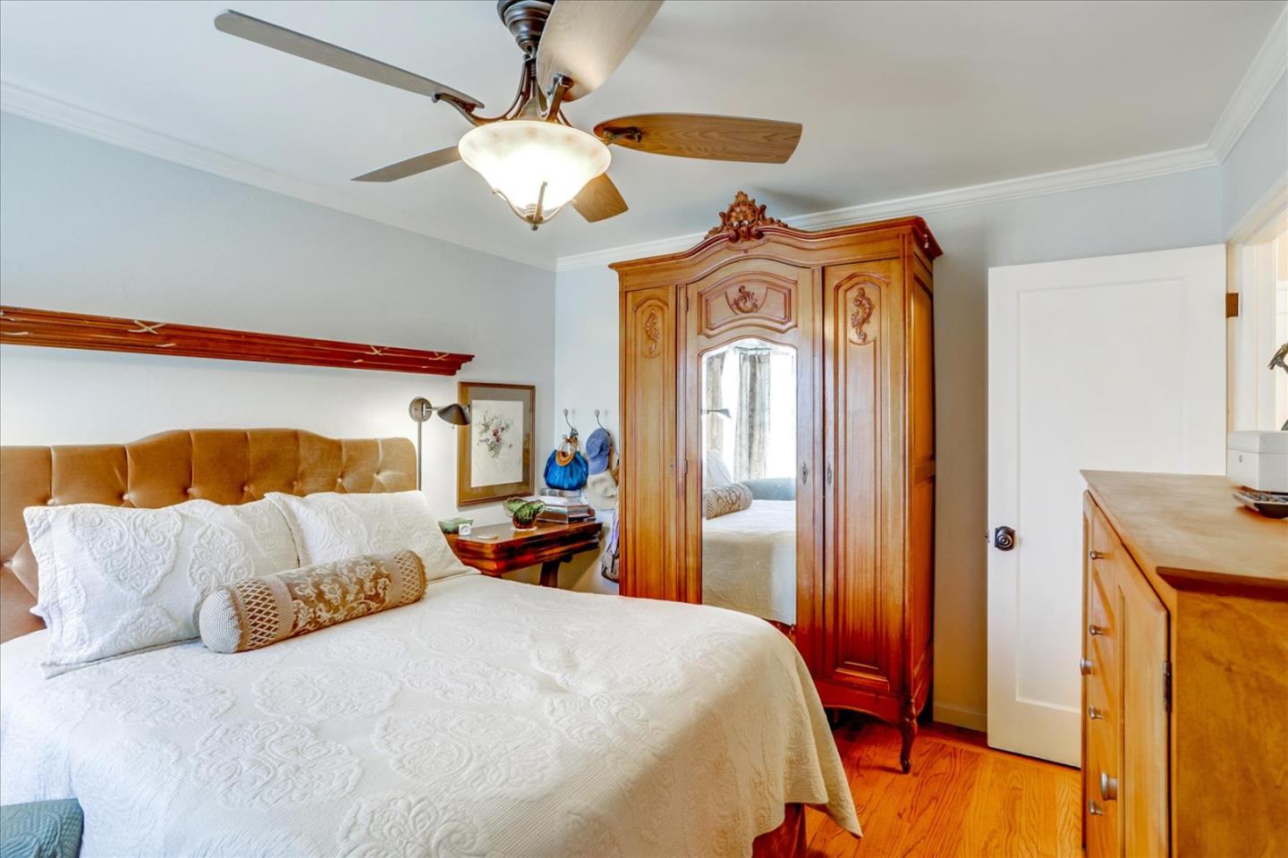 1130 Castro Street Mountain View, CA 94040 - Photo 21 of 37 a bedroom with a bed and a chandelier