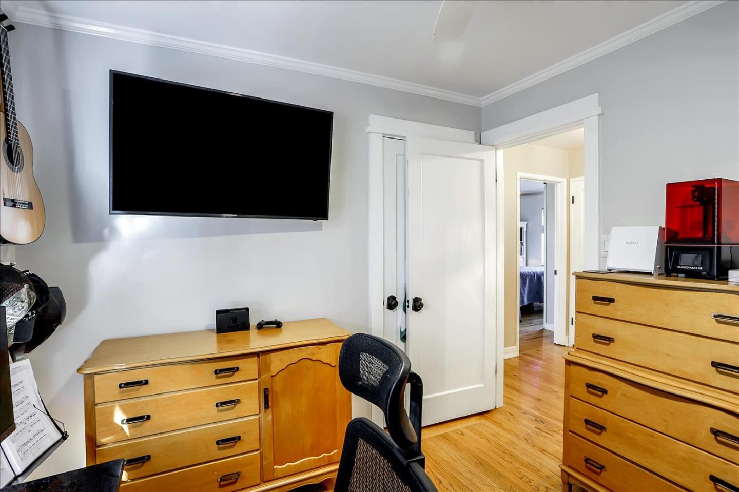 1130 Castro Street Mountain View, CA 94040 - Photo 25 of 37 a view of a bedroom with a flat tv screen and a dresser