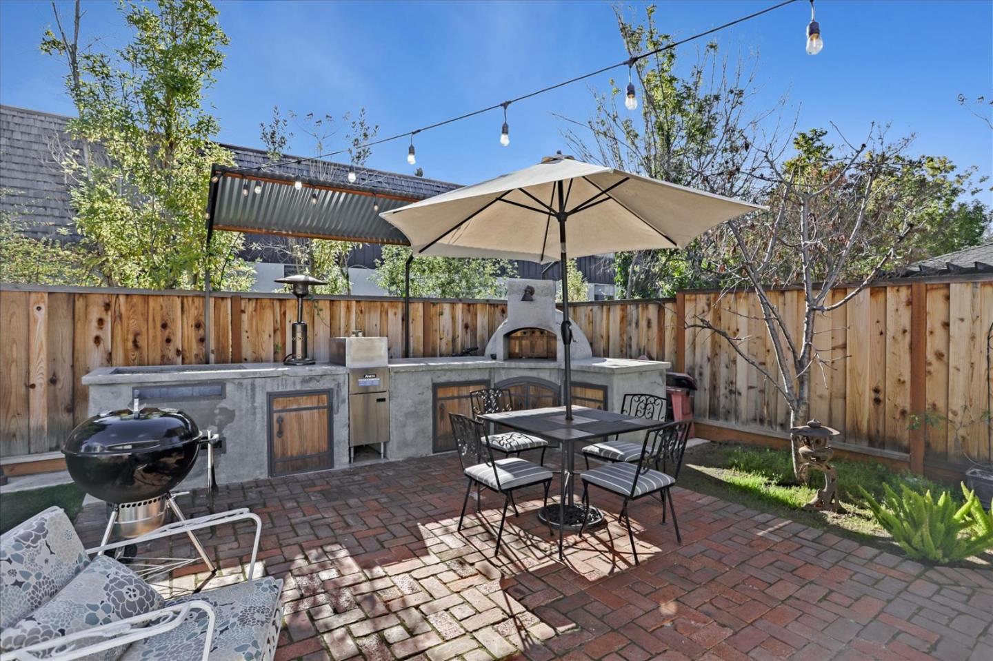 1130 Castro Street Mountain View, CA 94040 - Photo 29 of 37 a view of a patio with a table and chairs under an umbrella