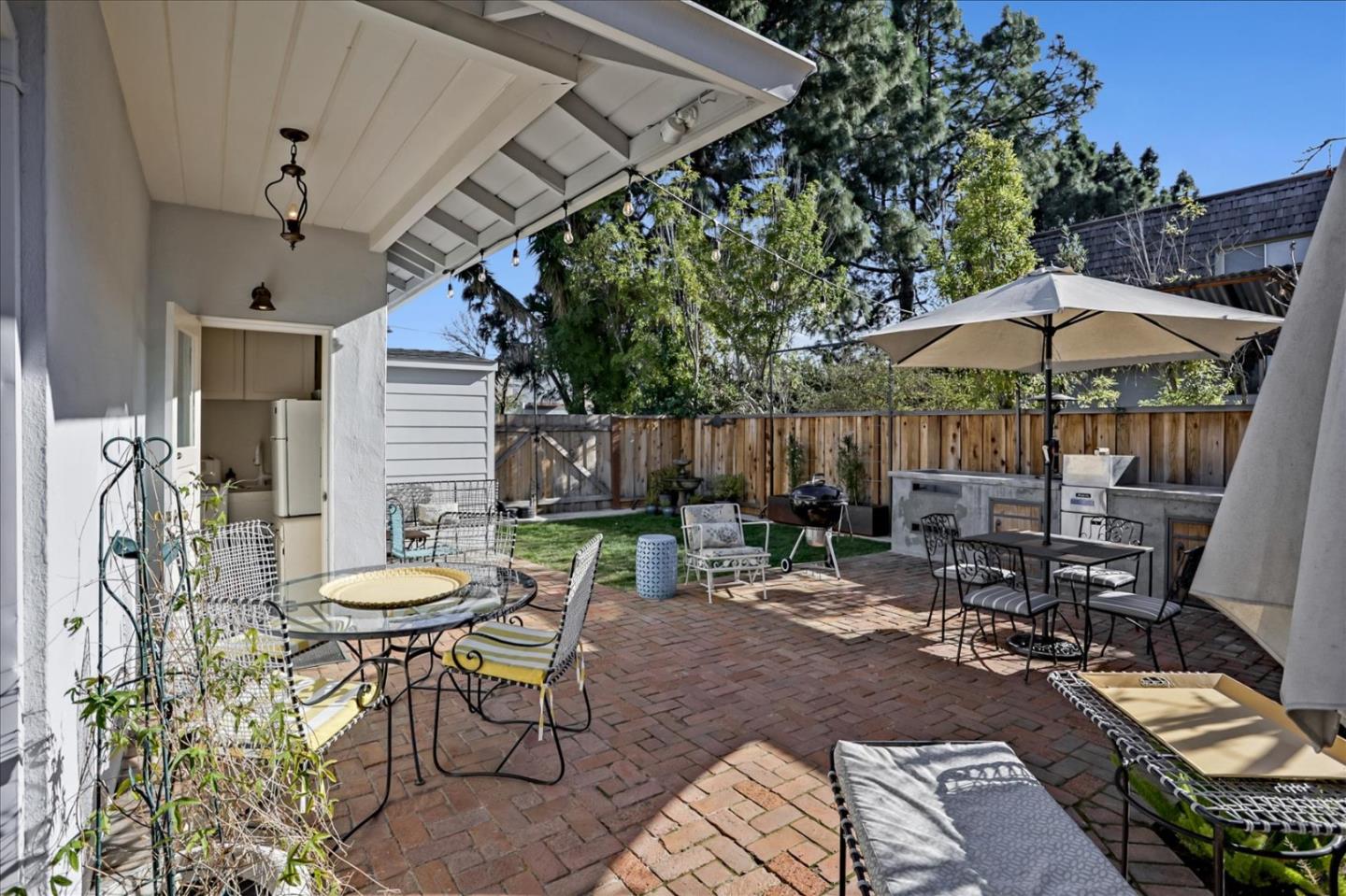 1130 Castro Street Mountain View, CA 94040 - Photo 30 of 37 a view of a patio with chairs and table under an umbrella