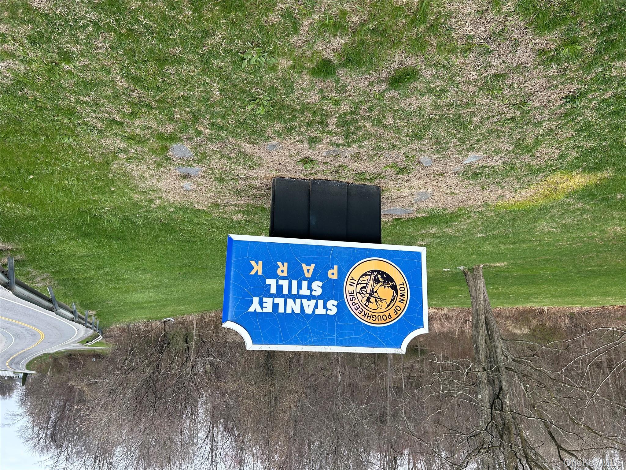 67 North Jackson Road Poughkeepsie, NY 12603 - Photo 16 of 16 a sign that is sitting in the grass near a tree