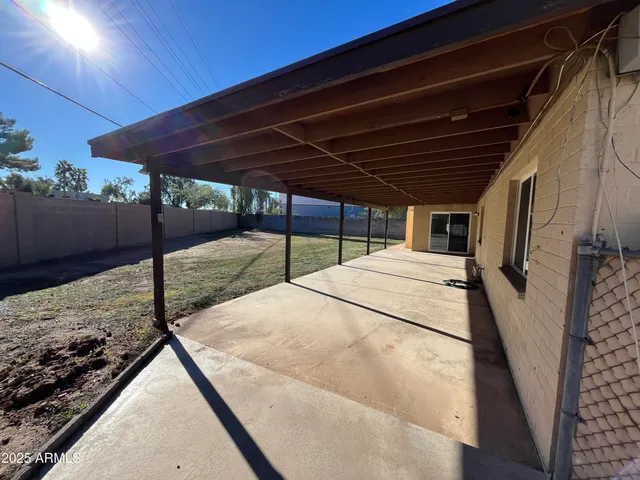 a view of a room with wooden floor and windows