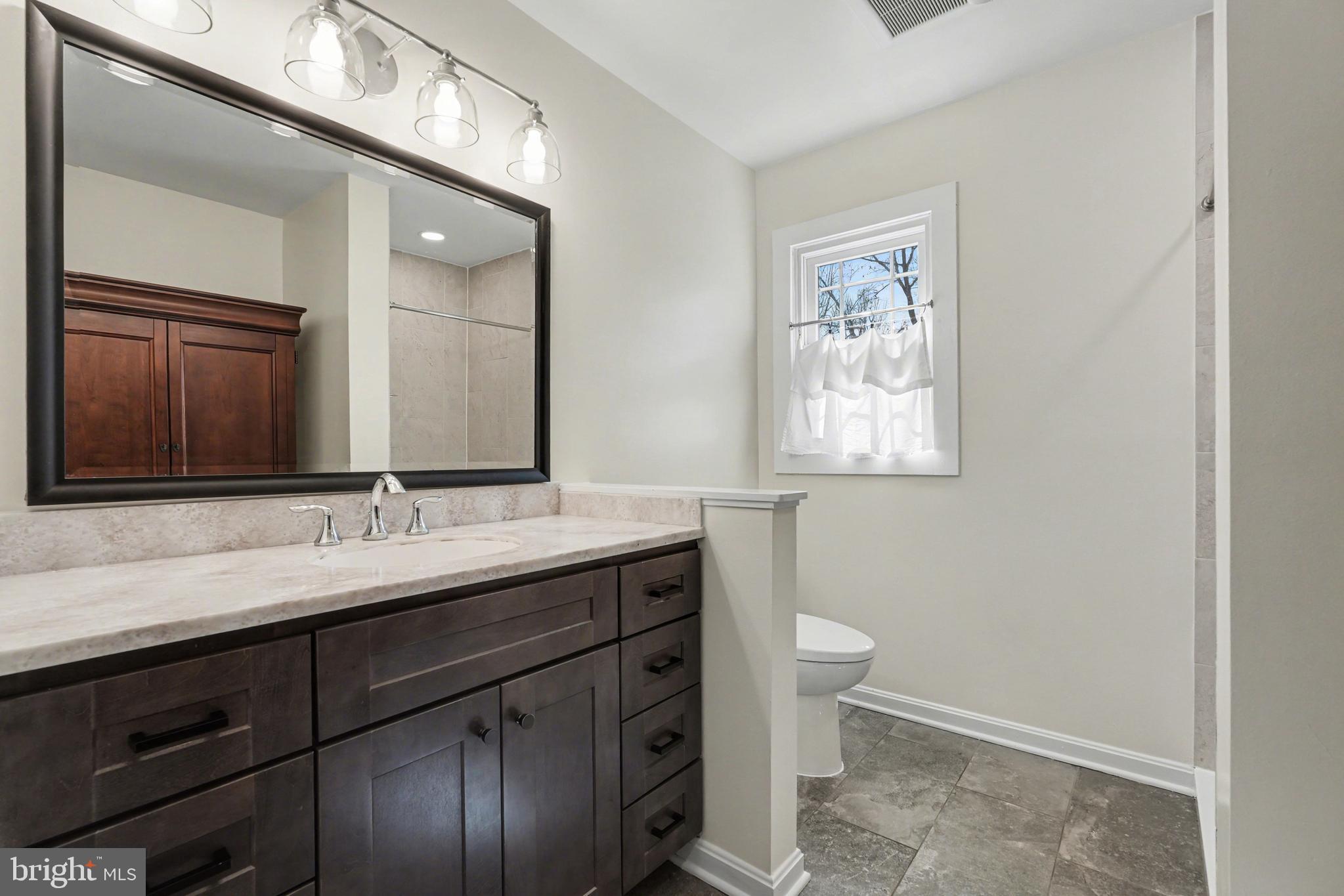 11080 Dutch Hollow Road Culpeper, VA 22701 - Photo 13 of 28 a bathroom with a double vanity sink and a mirror