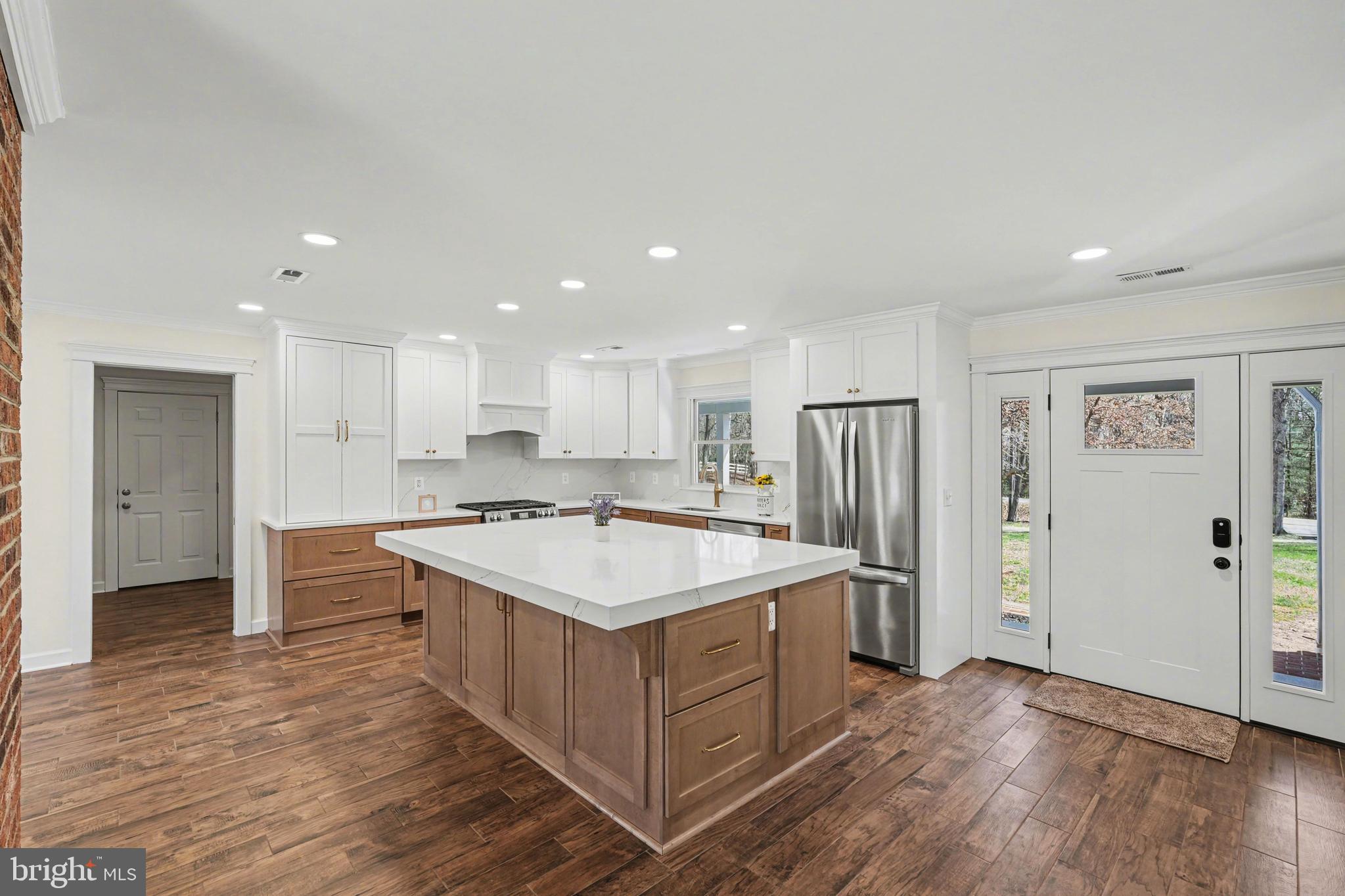 11080 Dutch Hollow Road Culpeper, VA 22701 - Photo 2 of 28 a kitchen with a sink a refrigerator and a stove top oven with wooden floor