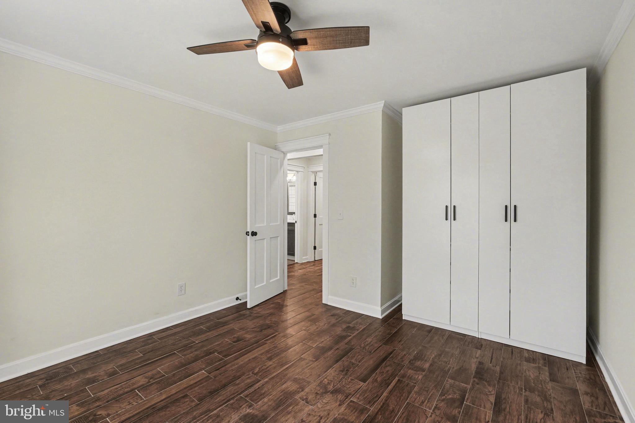 11080 Dutch Hollow Road Culpeper, VA 22701 - Photo 21 of 28 an empty room with wooden floor ceiling fan and windows