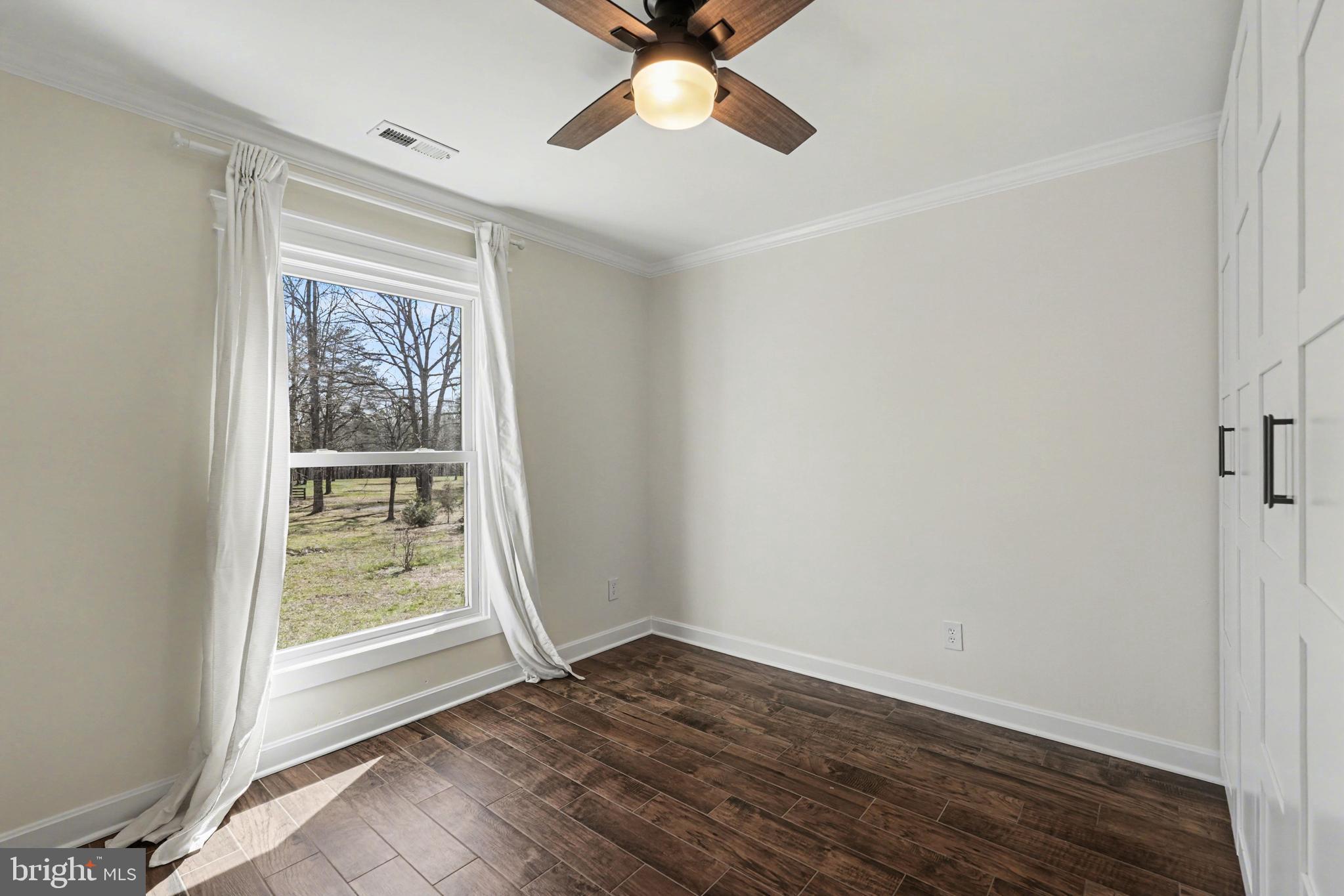 11080 Dutch Hollow Road Culpeper, VA 22701 - Photo 23 of 28 a view of an empty room with a window and wooden floor