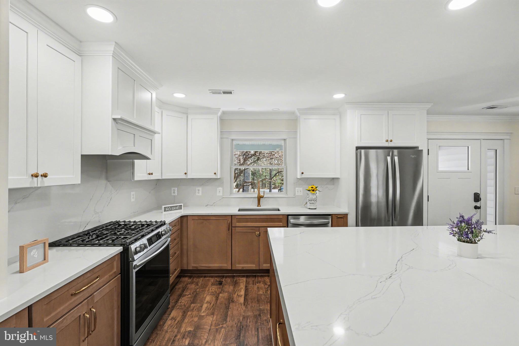 11080 Dutch Hollow Road Culpeper, VA 22701 - Photo 5 of 28 a kitchen with stainless steel appliances a sink a stove a refrigerator cabinets and a counter top space