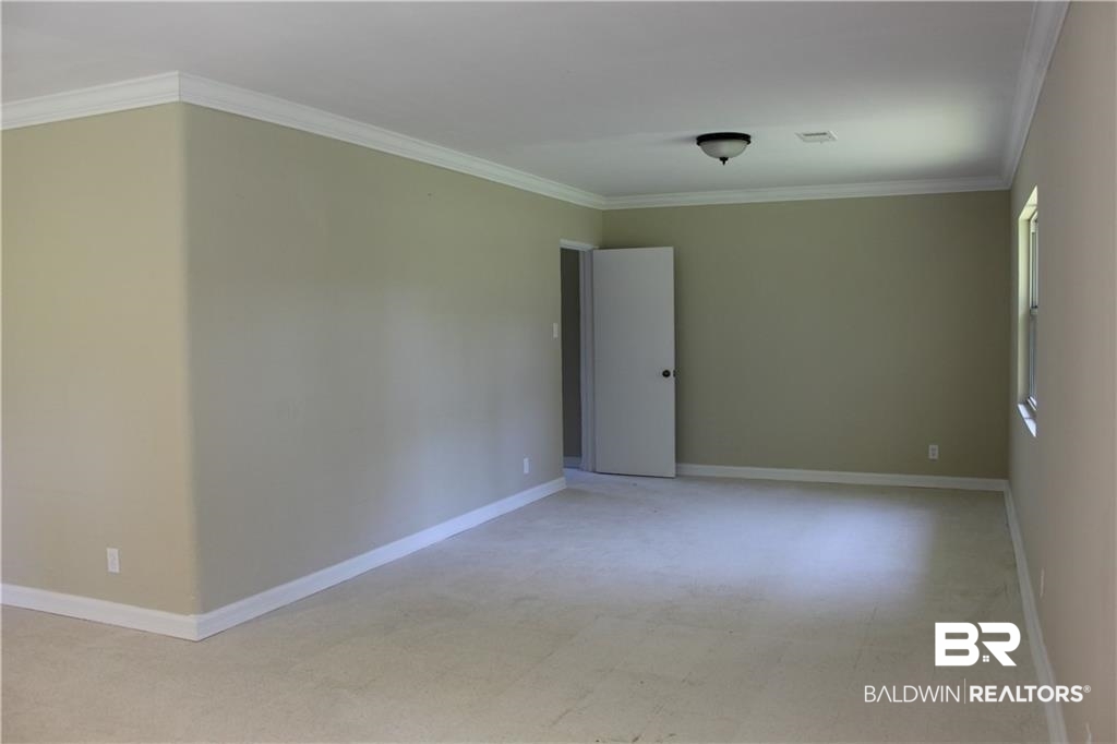 5710 Antoine Road Mobile, AL 36693 - Photo 4 of 7 Spare room with crown molding
