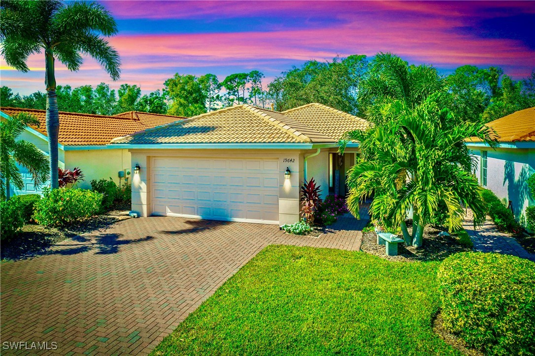 19642 Villa Rosa Loop Estero, FL 33967 - Photo 1 of 27 a front view of a house with a garden and yard