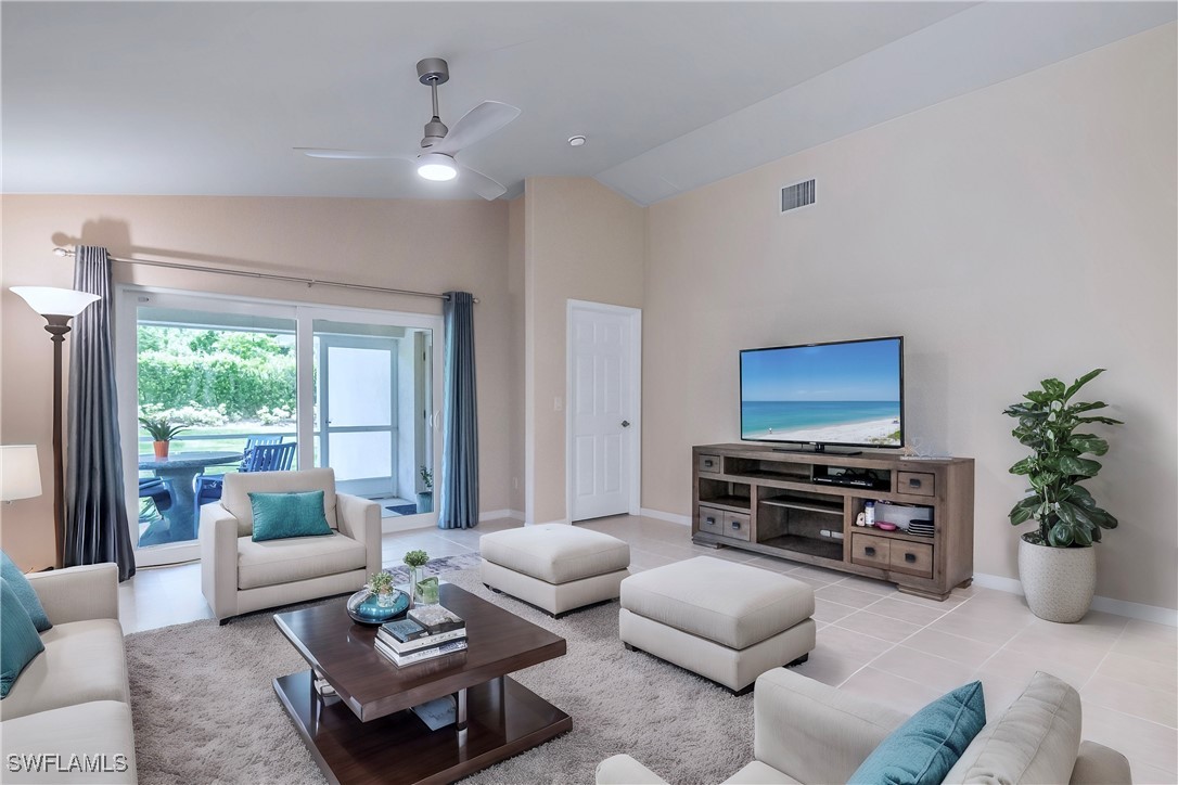 19642 Villa Rosa Loop Estero, FL 33967 - Photo 11 of 27 a living room with furniture a flat screen tv and a large window
