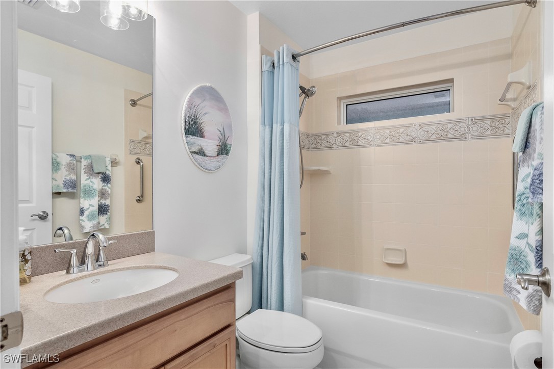 19642 Villa Rosa Loop Estero, FL 33967 - Photo 15 of 27 a bathroom with a granite countertop sink toilet a mirror and shower