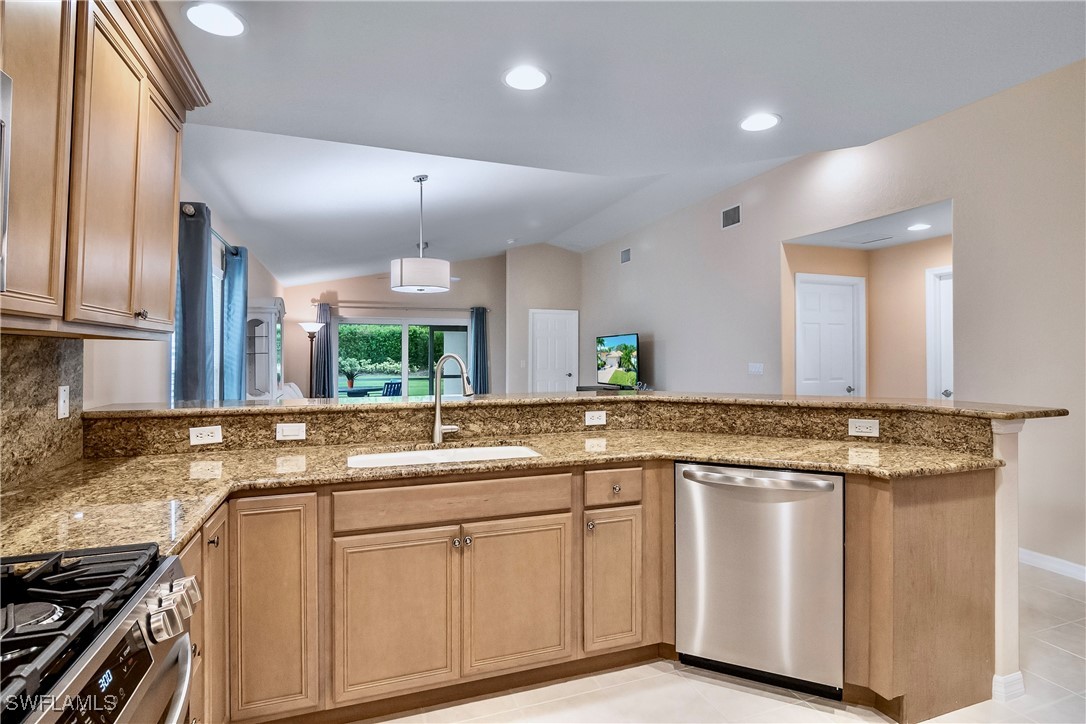 19642 Villa Rosa Loop Estero, FL 33967 - Photo 8 of 27 a kitchen with granite countertop a sink and white cabinets