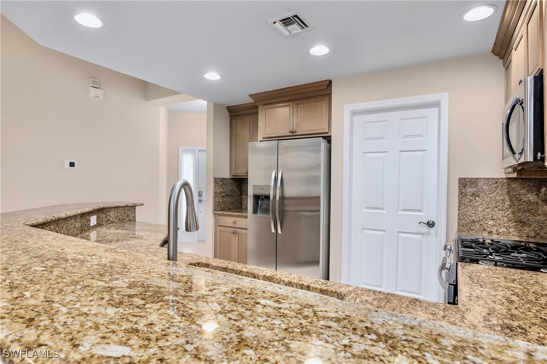 19642 Villa Rosa Loop Estero, FL 33967 - Photo 9 of 27 a view of a kitchen with a refrigerator and a sink