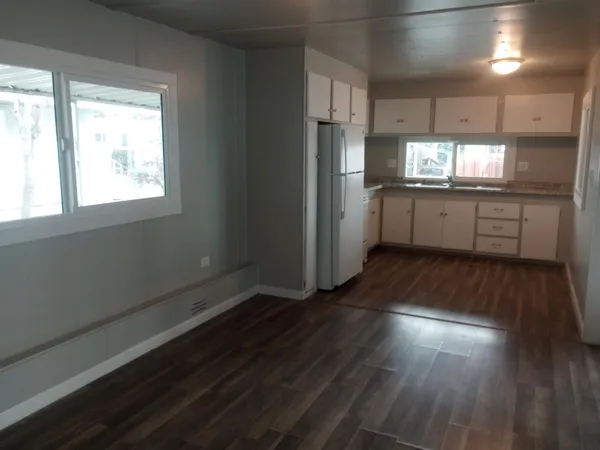 a kitchen with stainless steel appliances a refrigerator and a stove top oven