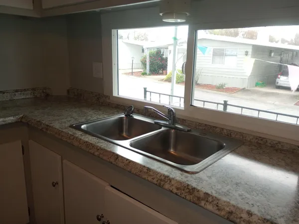 a kitchen with a sink and a large window
