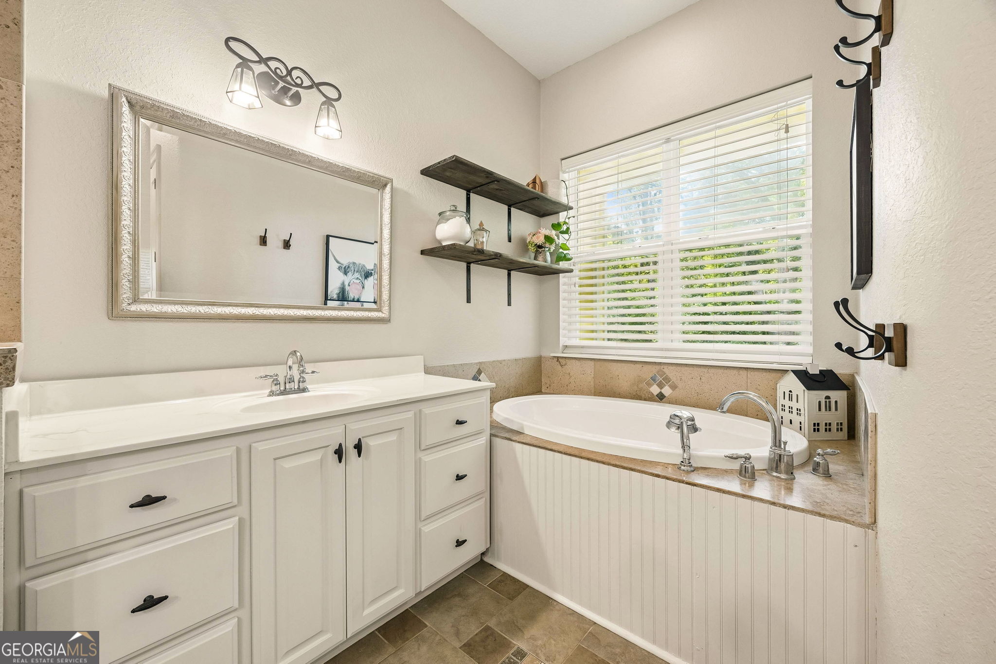 706 Hopewell Point Road White Oak, GA 31568 - Photo 35 of 84 Relax and unwind in the soaking tub surrounded by natural light, creating a peaceful spa-like retreat within the primary suite.