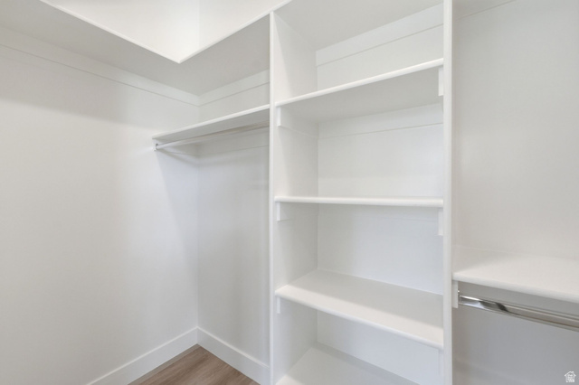 496 North Farmhouse Way, Unit 11 Midway, UT 84049 - Photo 34 of 50 Walk-in closet featuring white built-in shelving, white walls, and wood-finish flooring