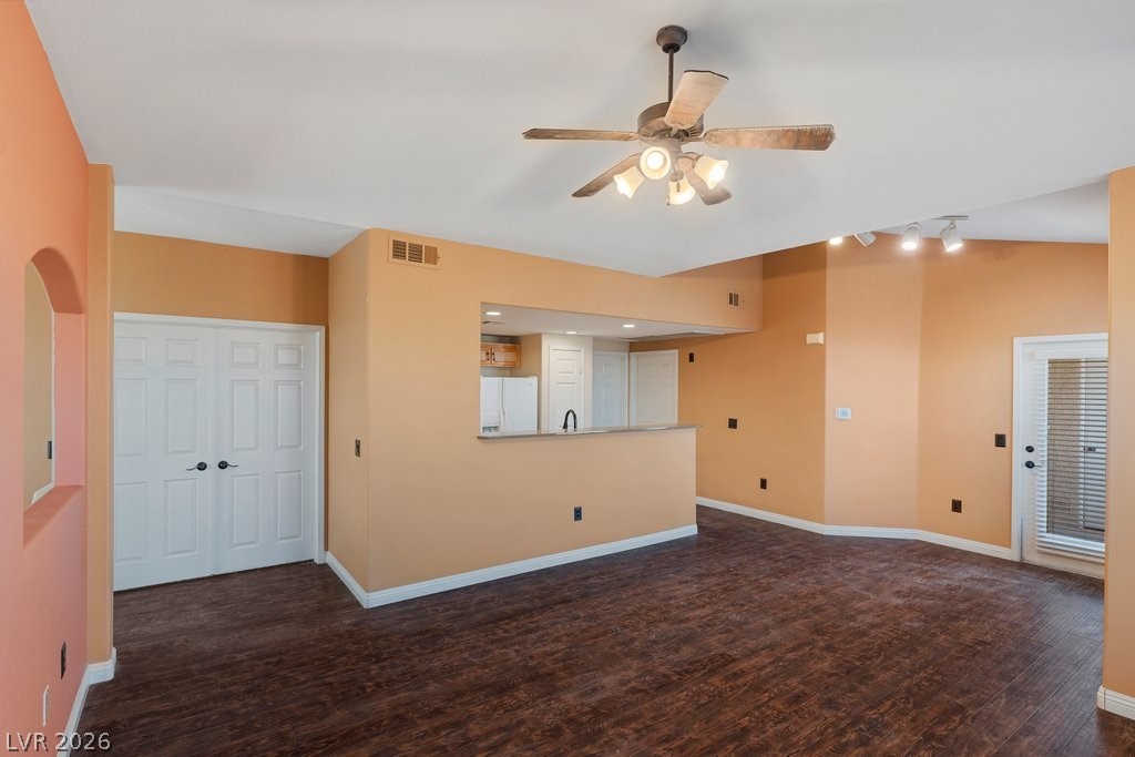 10001 Peace Way, Unit 2311 Las Vegas, NV 89147 - Photo 11 of 35 Unfurnished living room featuring ceiling fan and dark wood-style floors