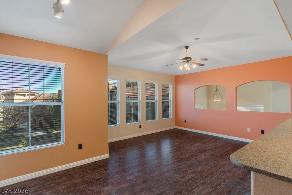 10001 Peace Way, Unit 2311 Las Vegas, NV 89147 - Photo 12 of 35 Unfurnished living room featuring dark wood-style flooring and ceiling fan