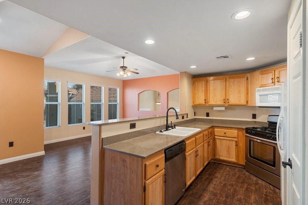 10001 Peace Way, Unit 2311 Las Vegas, NV 89147 - Photo 13 of 35 Kitchen featuring stainless steel appliances, a peninsula, ceiling fan, dark wood-type flooring, and recessed lighting