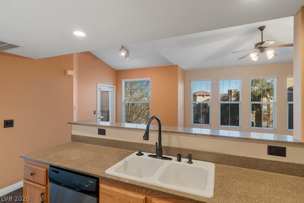 10001 Peace Way, Unit 2311 Las Vegas, NV 89147 - Photo 14 of 35 Kitchen with dishwasher, a ceiling fan, and light stone counters