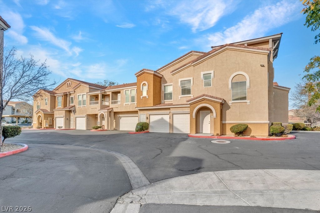 10001 Peace Way, Unit 2311 Las Vegas, NV 89147 - Photo 26 of 35 Mediterranean / spanish-style home featuring stucco siding, a garage, and driveway