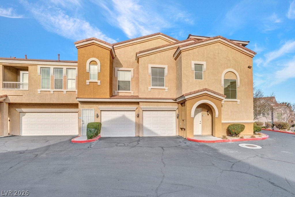 10001 Peace Way, Unit 2311 Las Vegas, NV 89147 - Photo 27 of 35 Mediterranean / spanish home with stucco siding, an attached garage, and driveway